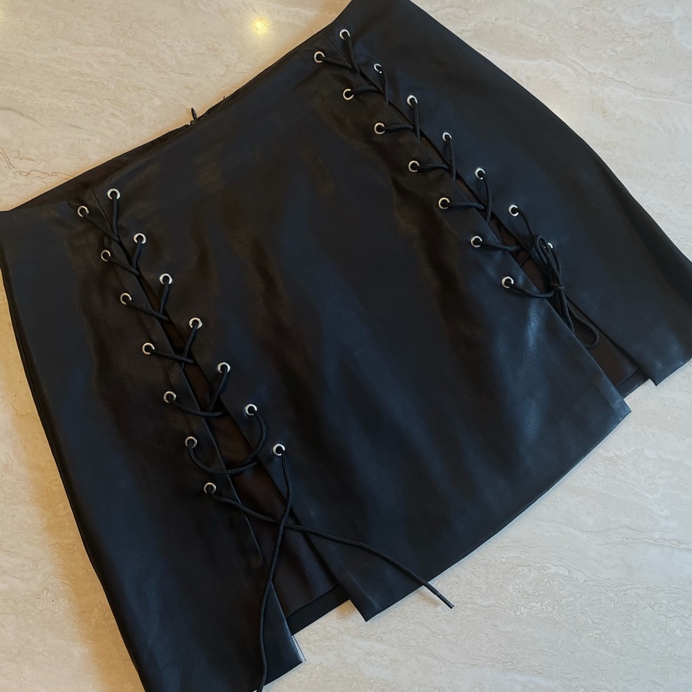 Faux leather, lace up, mini skirt. NEVER WORN